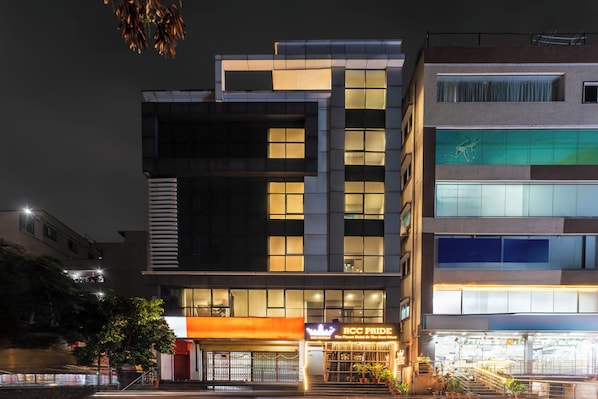 A modern hotel with multiple floors, large windows, and a prominent entrance with a sign. - Rcc Hotels Pride Kukatpally (Hyderabad)