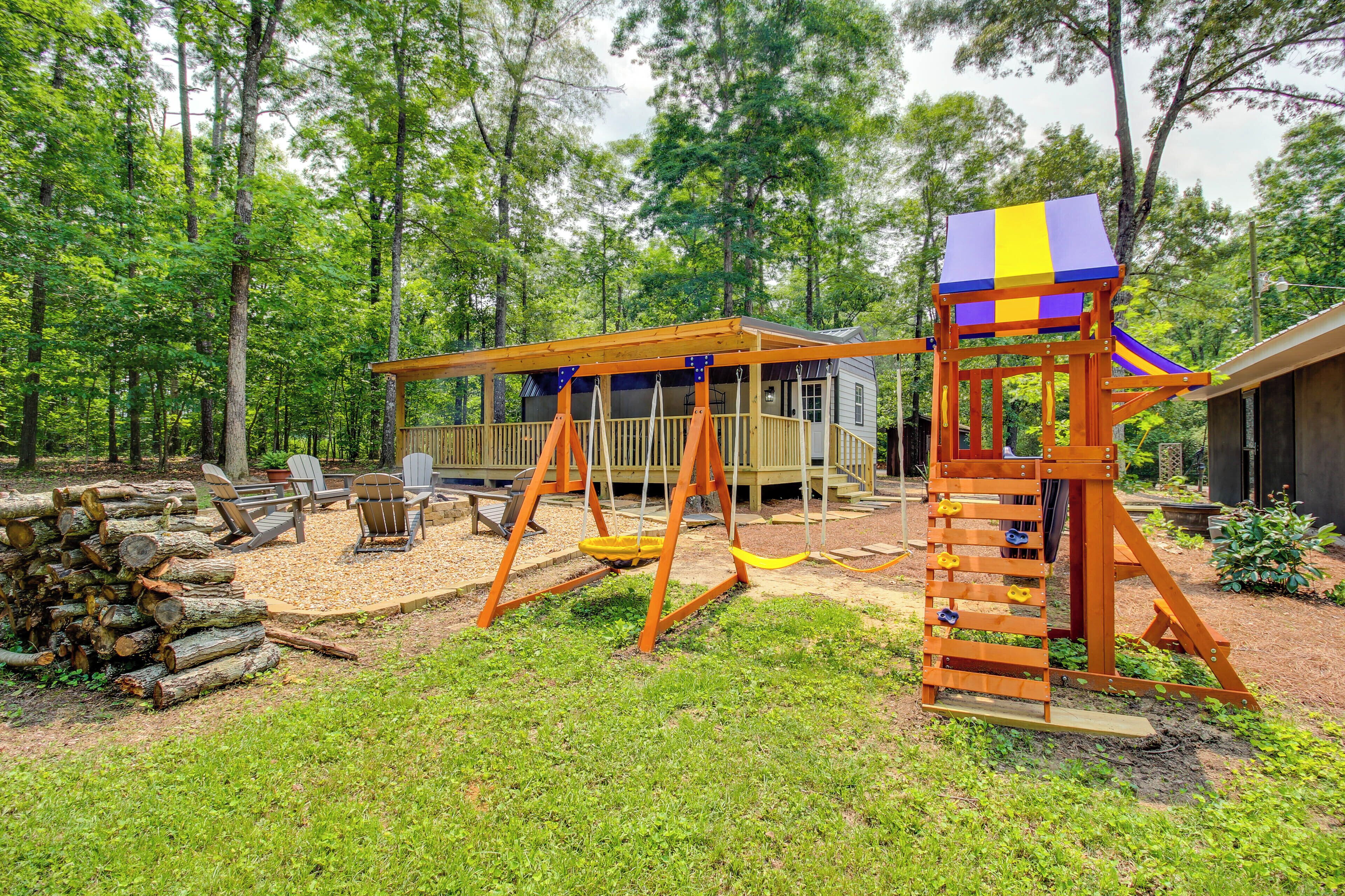 A playground with swings, a slide, and a climbing structure.