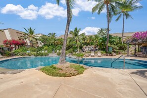 A pool area with palm trees, lounge chairs, and a clear sky. - Spacious Ground-Floor 2BR with AC & Garden Views, Walk to Beach- Maui Kamaole F107 (Kihei)