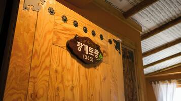 A wooden wall with a sign that reads 'Gyeongju' and the number '12031'.