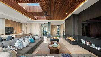 A modern living room with a sofa, coffee table, and a fireplace.