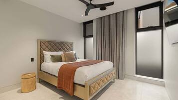 A bedroom with a bed, a ceiling fan, a window with curtains, and a small wooden stool.