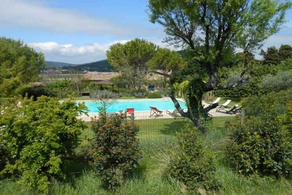 A pool area with lounge chairs and a clear view of the surrounding landscape.