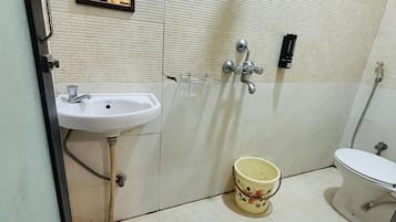 Un baño con lavamanos, inodoro y espejo.