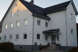 A two-story residential building with a grey facade, multiple windows, and a covered entrance. - Holiday apartment in Kötz with Wi-Fi (Kötz)