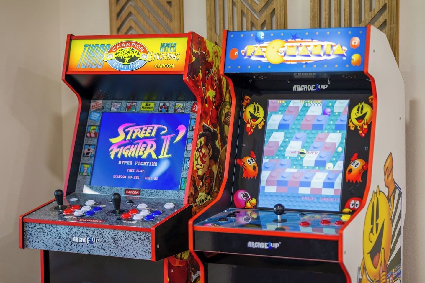 Two arcade machines with 'Street Fighter II' and 'Pac-Man' games.
