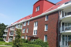 A multi-story residential building with brick facade, balconies, and windows. - Residence Hohe Lith Type D (Cuxhaven-Duhnen)