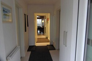 A hallway with a radiator, a framed picture, and a door leading to another room. - Holiday apartment with 2 bedrooms (Crinitzberg)