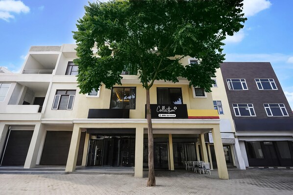 A multi-story building with a storefront labeled 'Collection' and 'OYO-Serviced.'