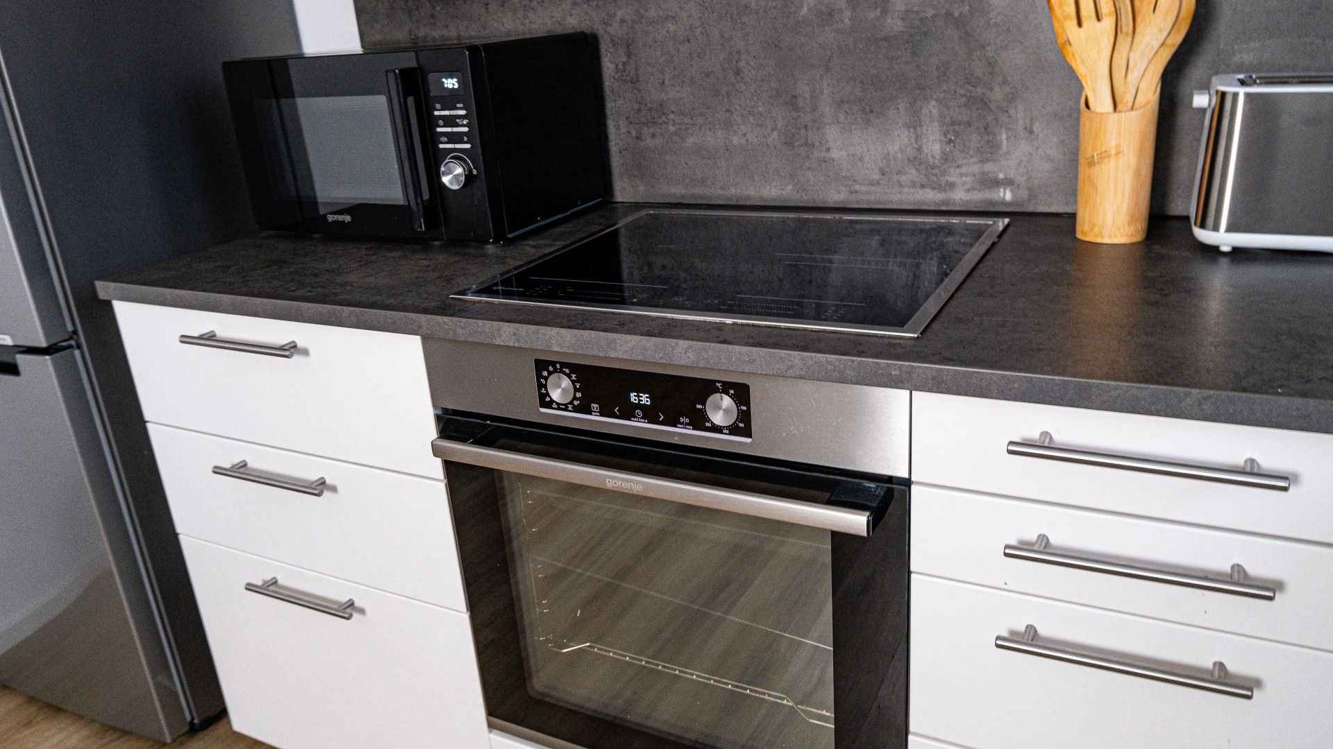 A kitchen with a microwave, toaster, and oven.