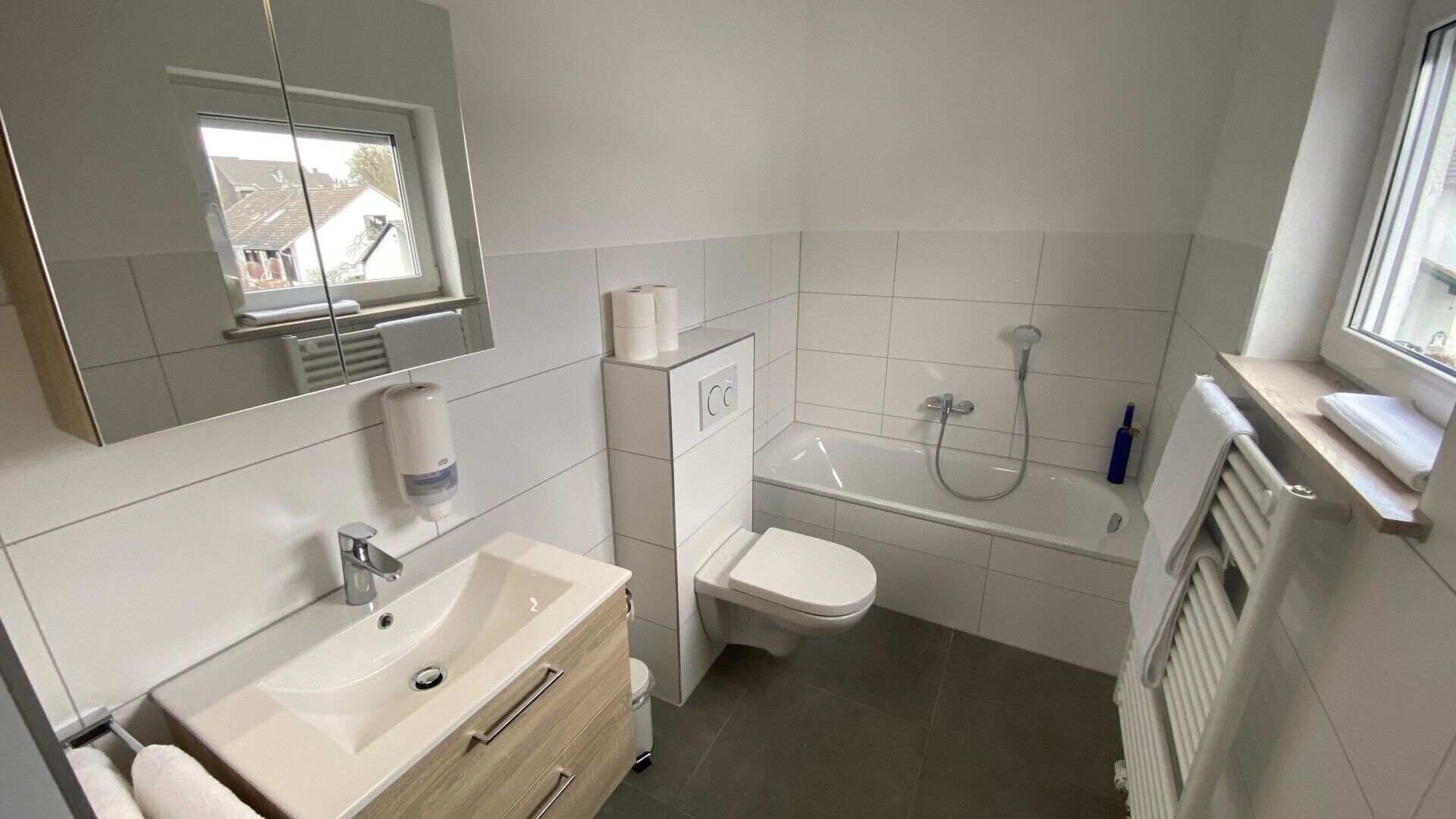 A bathroom with a sink, toilet, and bathtub.
