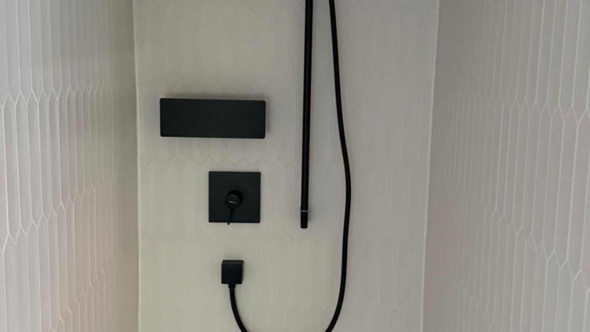 A wall-mounted electrical outlet with a power strip and a USB port.