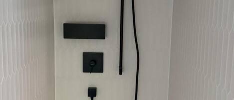 A wall-mounted electrical outlet with a power strip and a USB port.