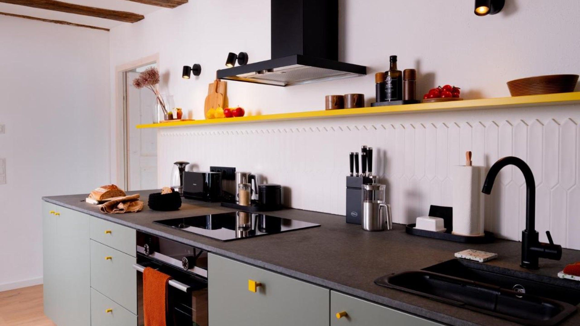 A modern kitchen with a central island, built-in appliances, and a variety of utensils and cookware.