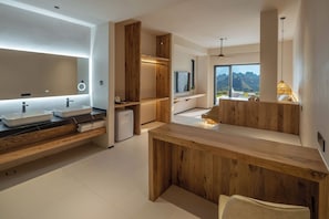 A modern bathroom with a large mirror, two sinks, and a built-in shower area.