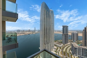 A high-rise building with a view of a body of water and other buildings. - Exquisite 1 Bed l Creek Skyline View l Gym & Pool (Dubai)