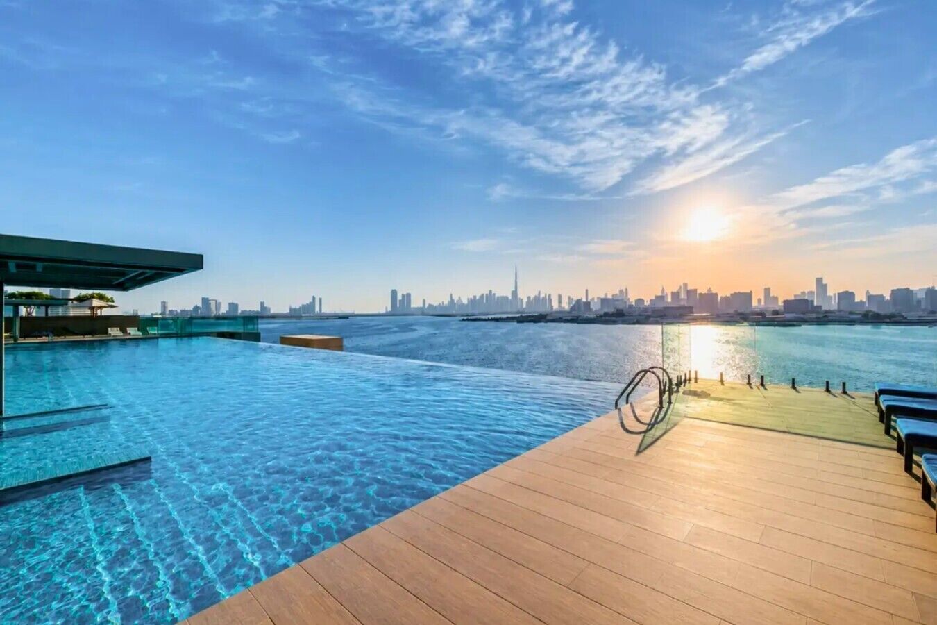 A swimming pool with a city skyline in the background.