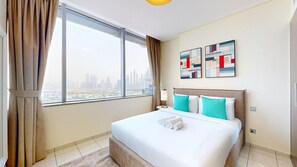 A hotel room with a large window, a bed with white bedding and teal pillows, and artwork on the wall. - Bustling 2 Bed in DIFC l near Museum of the Future (DIFC)