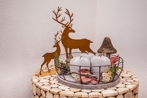 A decorative metal stand with a rustic design, featuring a silhouette of a deer and a mushroom. - Bergblick Buchwieser (Unterammergau)
