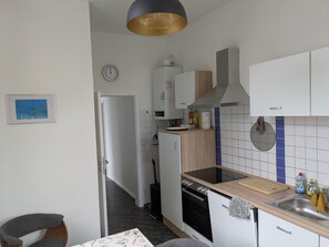 A modern kitchen with a microwave, stove, and sink.
