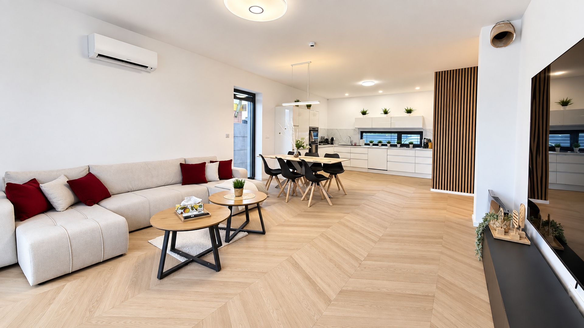 A modern living room with a sofa, coffee table, and dining area.