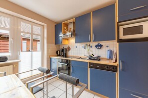 A compact kitchen with a built-in oven, microwave, and a coffee maker. - Laika Vacation Home in Dagebüll for up to 4 people (Dagebüll)