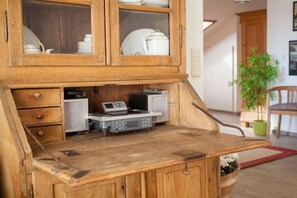A wooden kitchen counter with built-in appliances and a cabinet above.