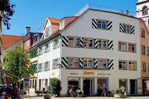 Ein mehrstöckiges Gebäude mit einem Café im Erdgeschoss.