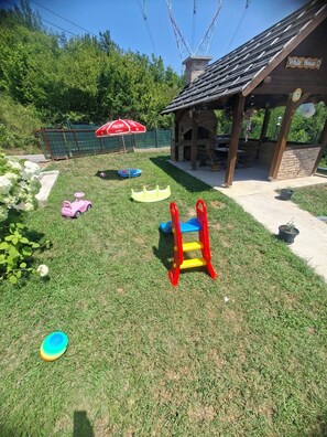 A children's play area with a slide, a swing set, and a covered seating area. - Private Family House with Garden & Gazebo Sleeps 10 Sarajevo (Sarajevo)
