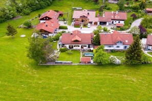 A residential area with multiple houses, a central building with a prominent entrance, and surrounding greenery. - Holiday apartment with 1 bedroom (Füssen)