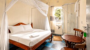 A bed with a canopy, a wooden chair, a small table, a sink, and a shower. - Bathi Gardens Retreat - Peaceful Naivasha Getaway in Nature (Naivasha)