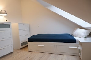 A bedroom with a bed, a nightstand, a dresser, and a desk. - Holiday home in Burhave with swimming pool (Burhave)