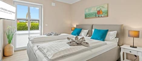 A hotel room with a bed, a nightstand, a window, and a painting on the wall.