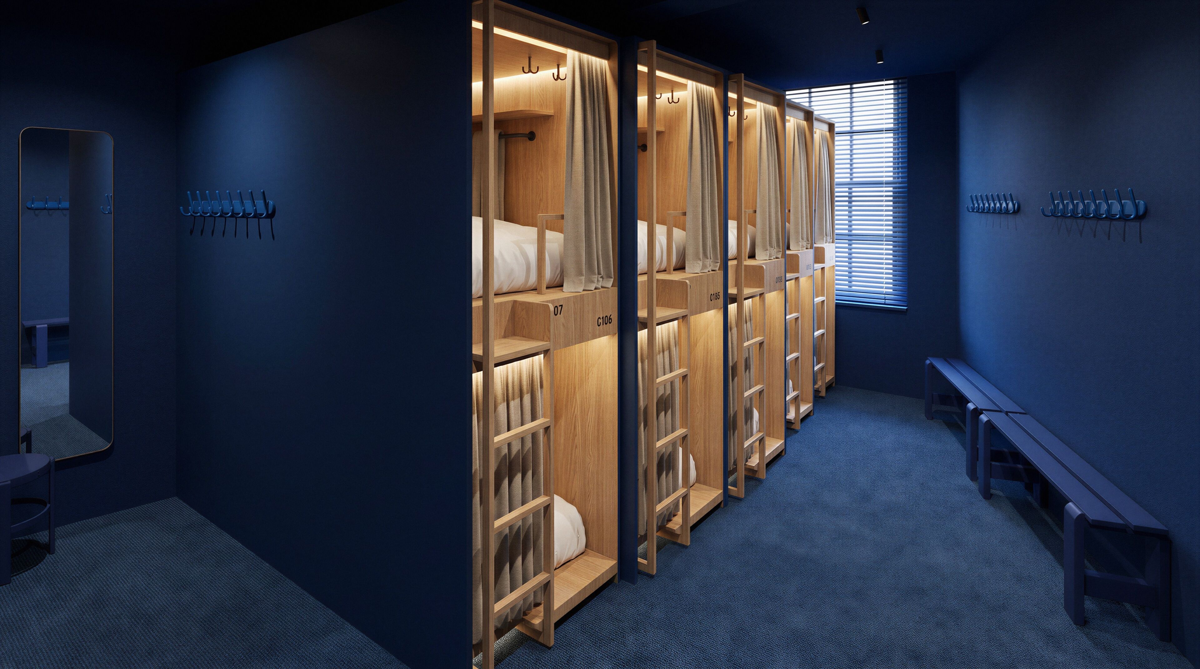 A row of wooden lockers with numbered compartments, a bench, and a window with blinds.