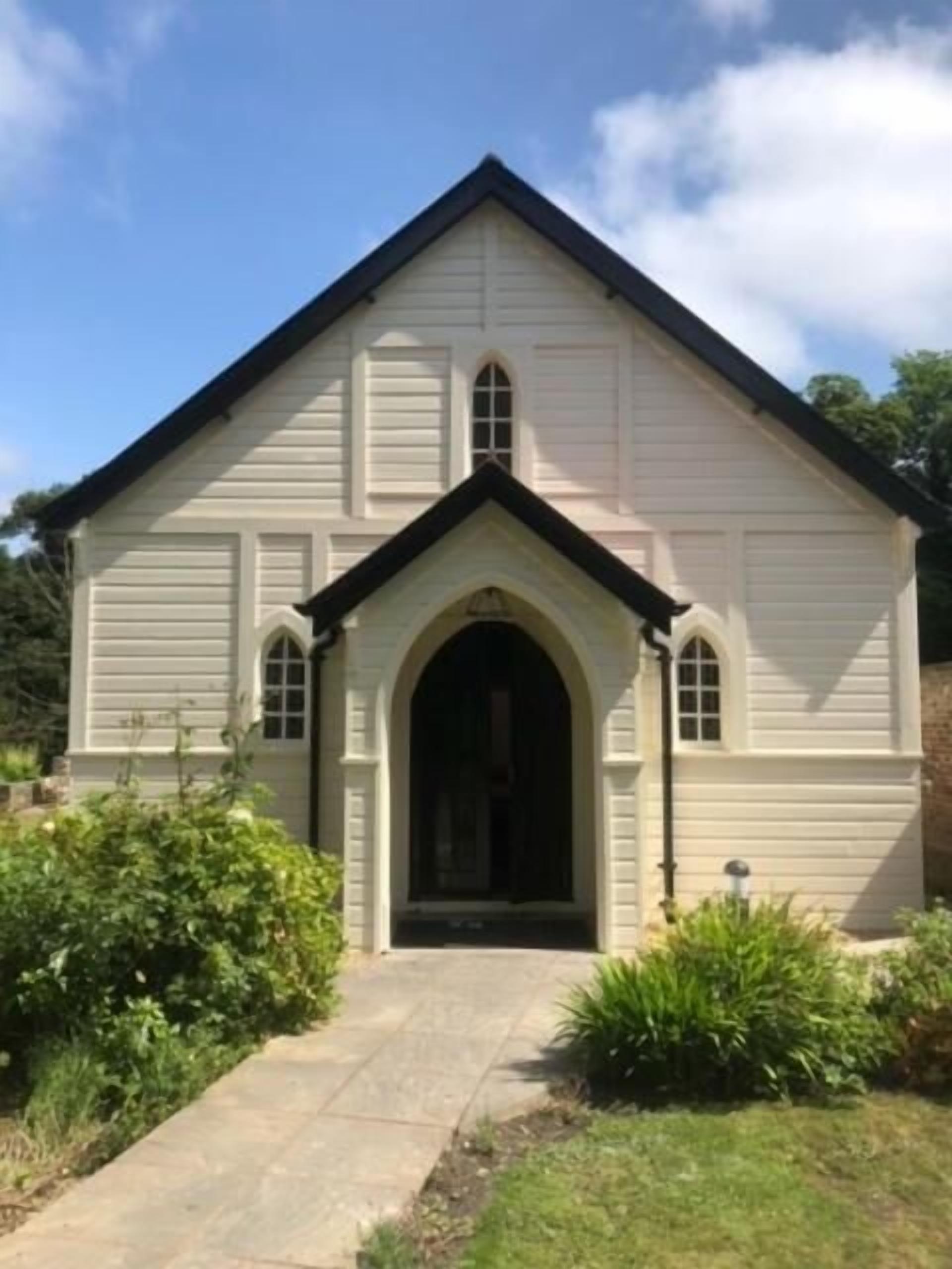 A building with a gabled roof and an arched entrance.