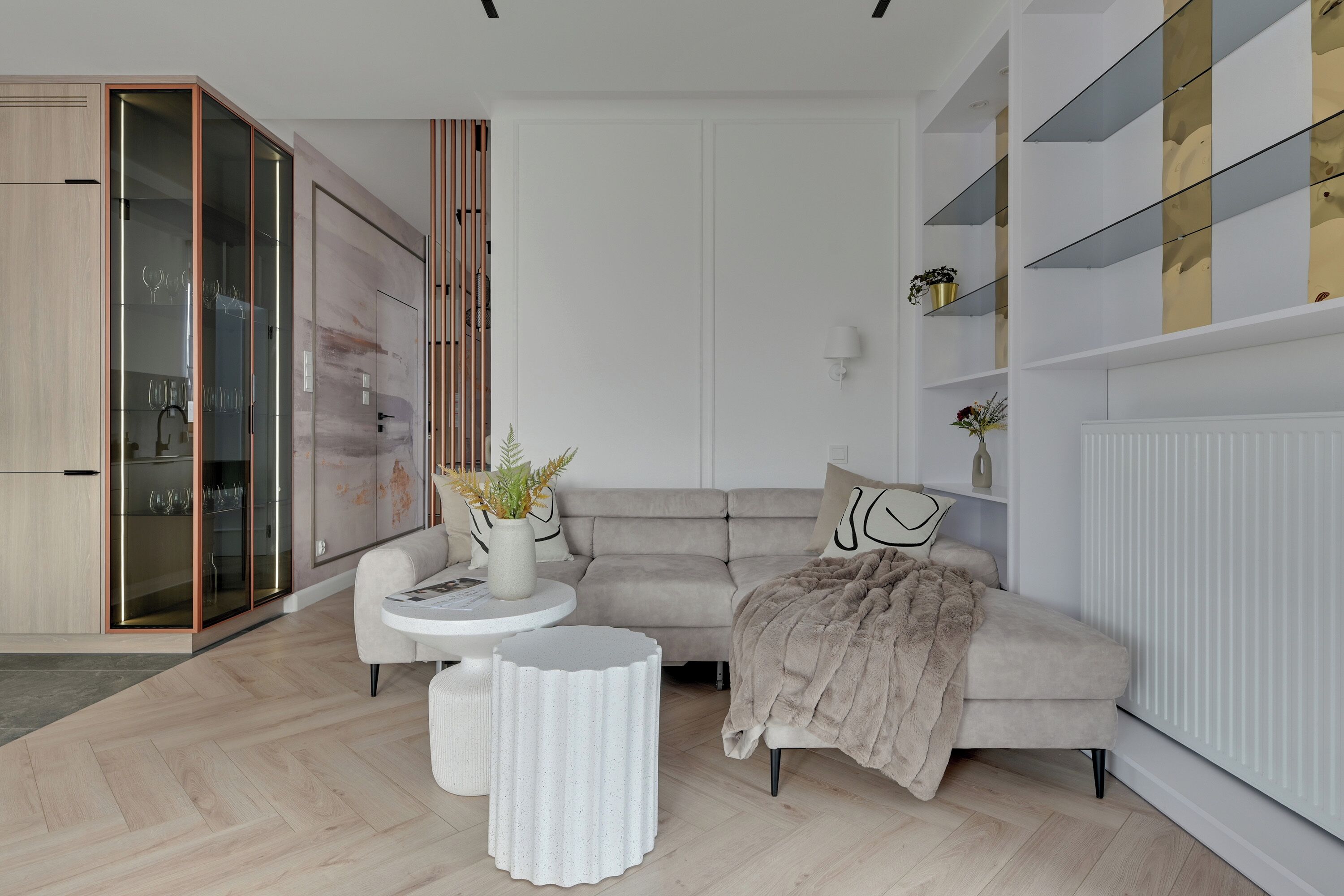 A modern living room with a sofa, a coffee table, and a cabinet with glass doors.