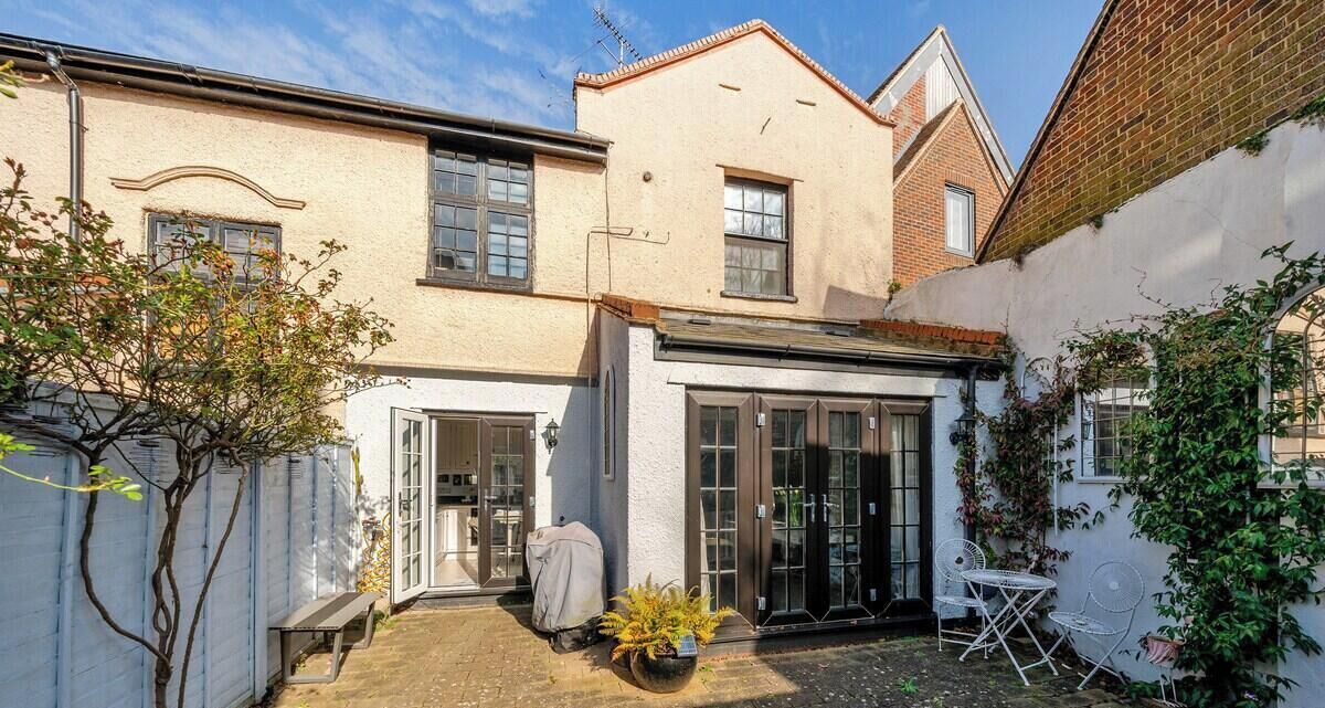 A residential property with a patio, a covered outdoor seating area, and a garden.