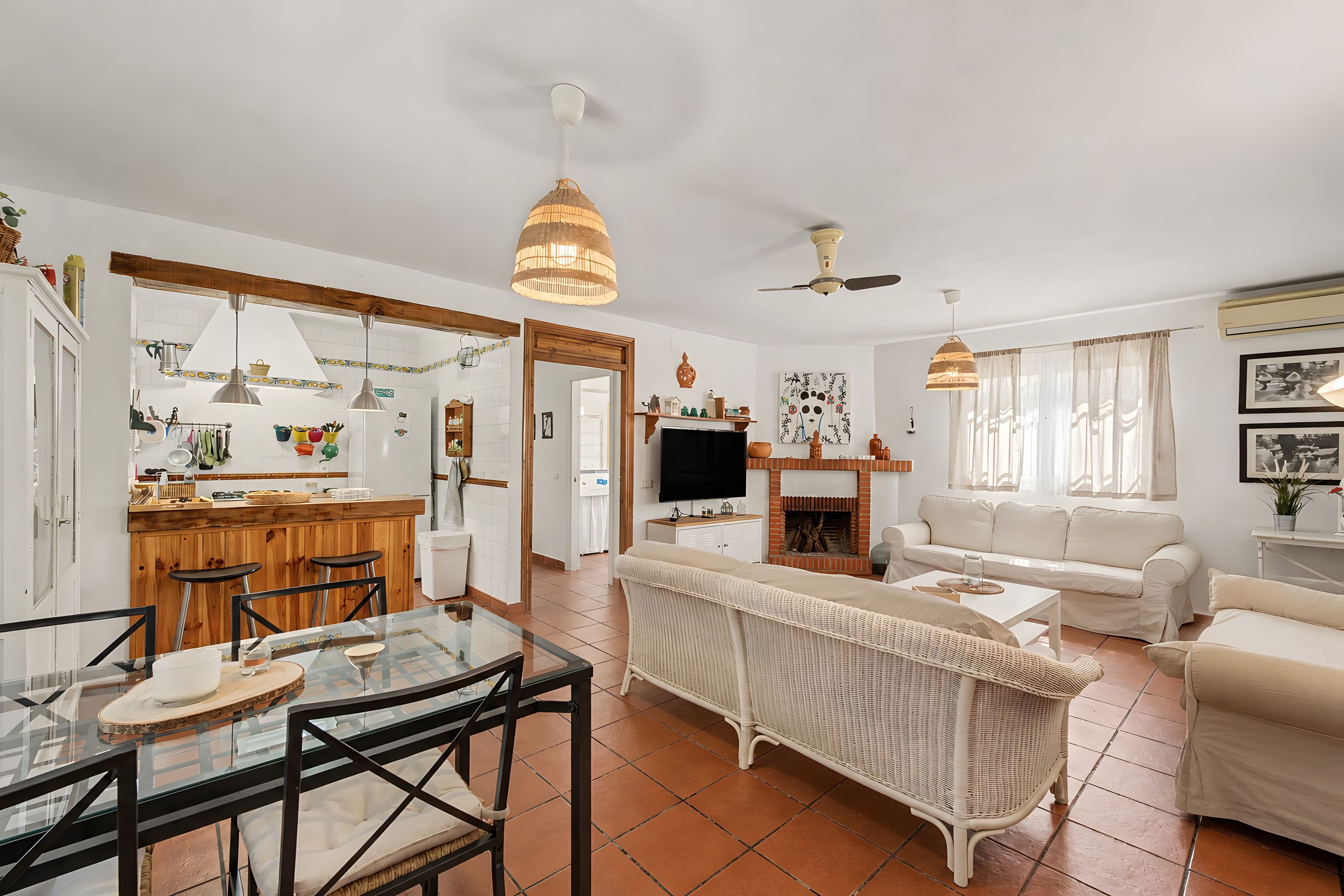 A spacious living area with a dining table, sofa, and a fireplace.