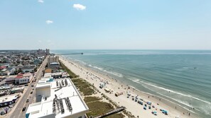 An aerial view of a coastal city with a beach, buildings, and a pier. - North Myrtle Beach | Oceanfront Family Stay | Pool & Beach | 3BR Sleeps 10 (North Myrtle Beach)