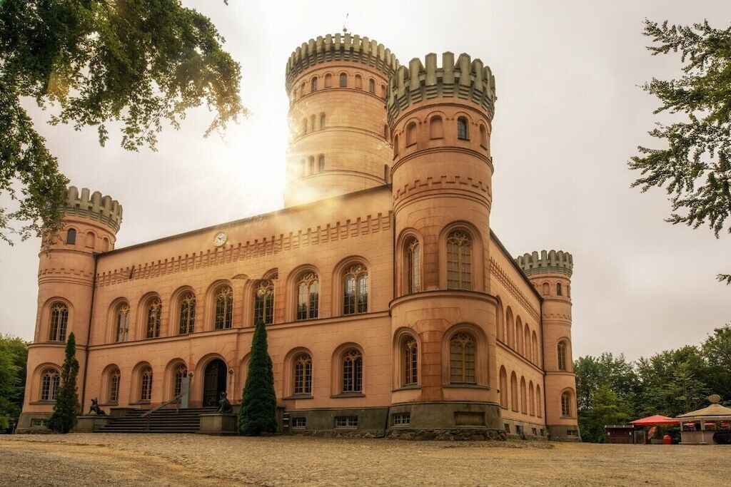 A castle-like building with multiple towers and arched windows.