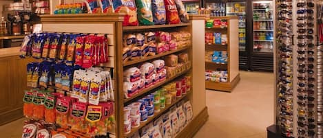 A grocery store with aisles stocked with snacks, cereals, and other food items.