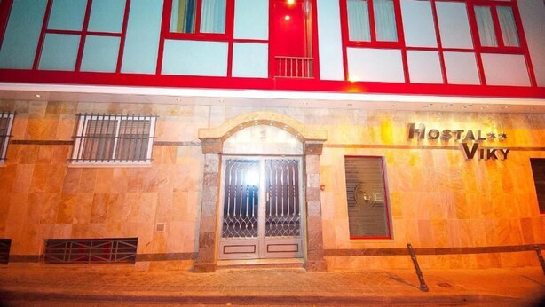 A building with a sign reading 'Hostal Viky' and a large arched entrance. - HOSTAL VIKY (Madrid)