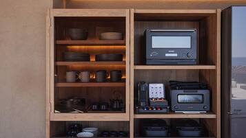 A kitchen with wooden cabinets, a built-in oven, a coffee maker, and various kitchenware.