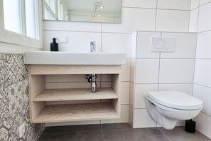 A bathroom with a white sink, a toilet, and a mirror. - AK13 Holiday home near Domburg (Aagtekerke)