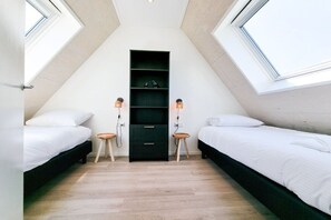 A bedroom with two beds, a built-in wardrobe, and a skylight. - AK13 Holiday home near Domburg (Aagtekerke)