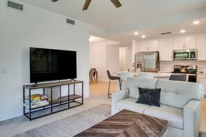 A modern living room with a flat-screen TV, a coffee table, and a sofa. - Punta Gorda Resort Condo: Pool Access, Lanai (Punta Gorda)