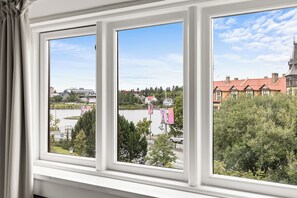 A window with a view of a lake, buildings, and trees. - Best View in Downtown Reykjavik!  3 Bedrooms + 3 Ensuite-Bathrooms (Reykjavík)