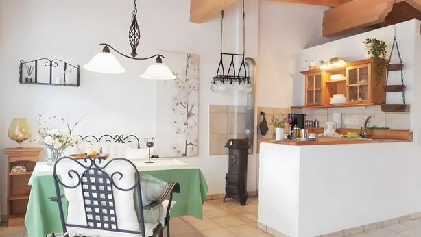 A dining area with a green table, chairs, and a chandelier. - Holiday Apartment for 3 People (59 m²) in La Sabinita with Sea View (La Sabinita)