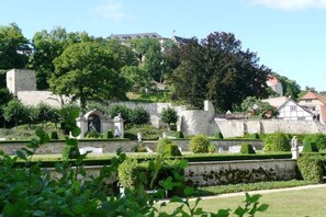 A historic stone wall with a gate, surrounded by well-maintained hedges and trees. - Holiday apartment Assenta (Blankenburg)