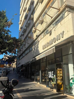 A Harmony hotel with a storefront and a sale sign. - Prestigious Suite Near Mamilla—View of the Ancient Walls (Jerusalem)
